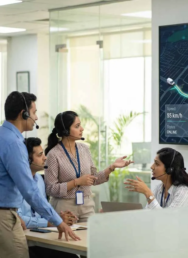 MetroRide Kids command centre team at their desks with headsets, monitoring live trips
